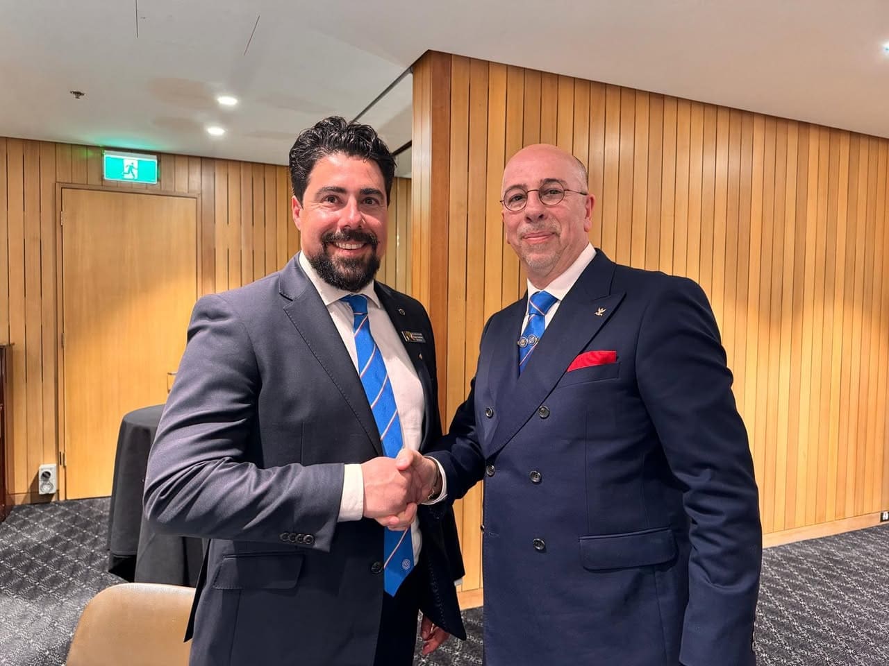 Two brethren shaking hands after the meeting